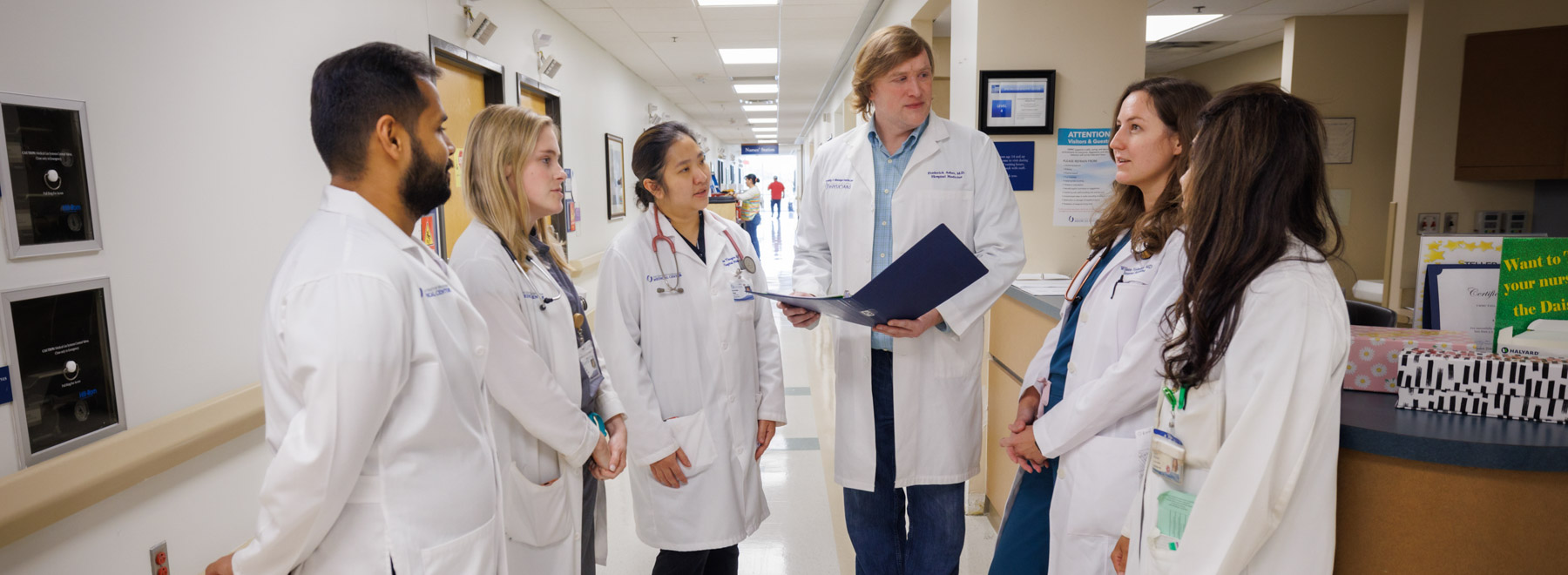 A group of hospitalists convene for a patient care discussion. A group of hospitalists convene for a patient care discussion.